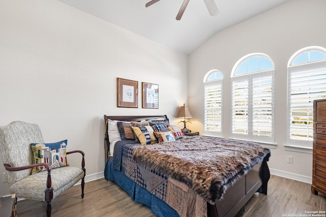 bedroom with lofted ceiling, ceiling fan, wood finished floors, and baseboards