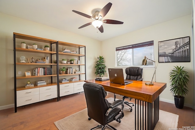 office area with ceiling fan, baseboards, and wood finished floors