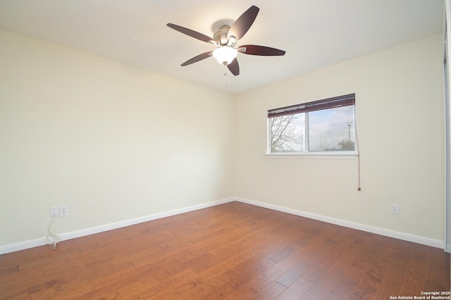 unfurnished room with a ceiling fan, baseboards, and wood finished floors