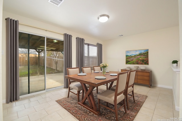 dining room with light tile patterned floors, baseboards, and visible vents