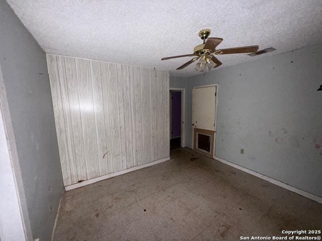 spare room featuring visible vents, ceiling fan, and a textured ceiling