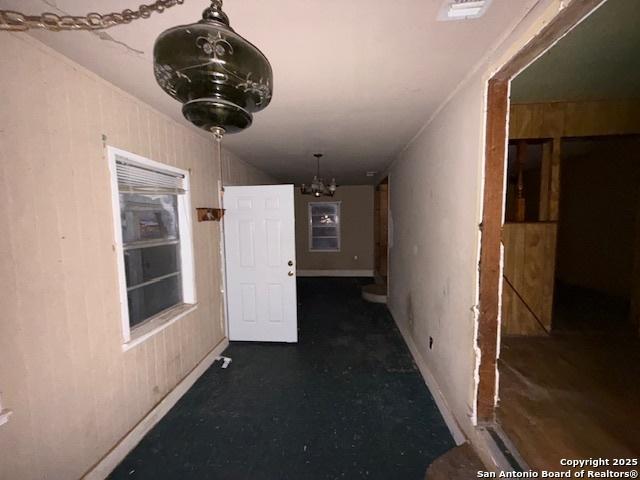 corridor with visible vents and a notable chandelier