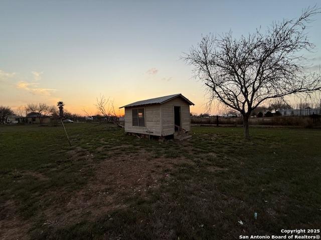 yard at dusk with an outdoor structure