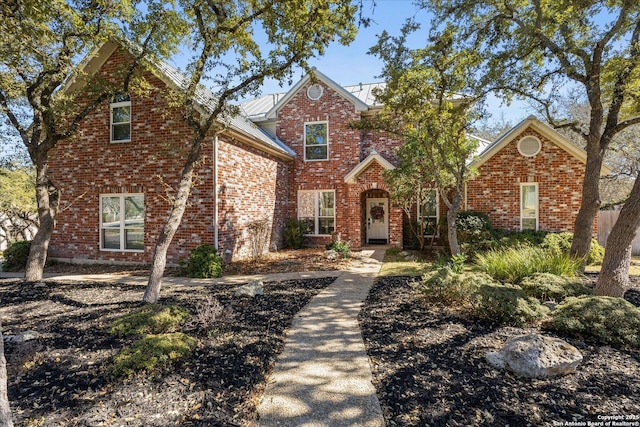 traditional-style house featuring brick siding