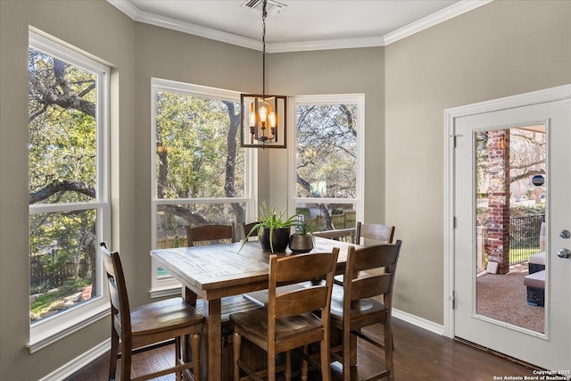 dining area featuring ornamental molding, plenty of natural light, visible vents, and dark wood finished floors