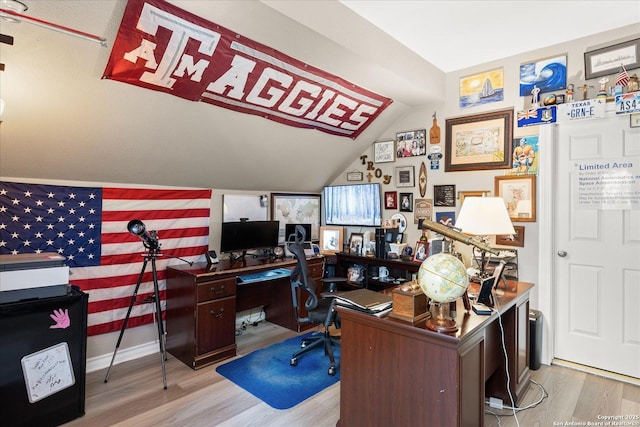 office space featuring lofted ceiling, baseboards, and wood finished floors