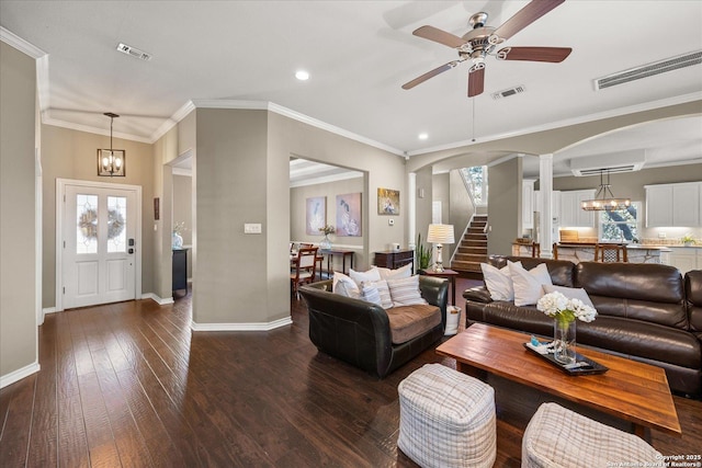 living area with stairs, visible vents, and hardwood / wood-style floors