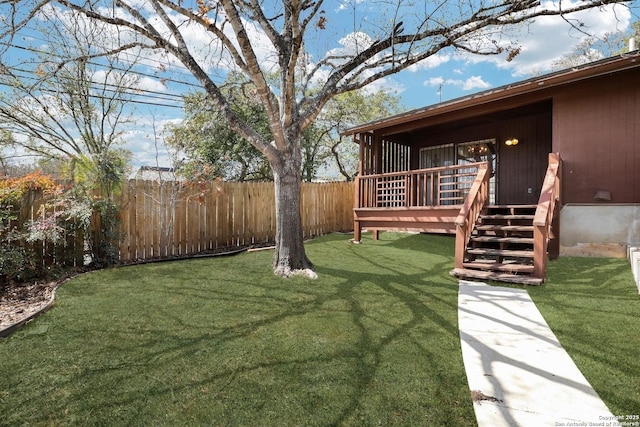 view of yard with a deck and fence