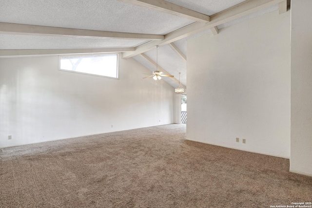 unfurnished room with a healthy amount of sunlight, carpet flooring, beamed ceiling, and a textured ceiling