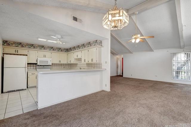 kitchen with white appliances, beam ceiling, visible vents, and light colored carpet