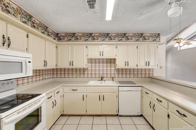 kitchen with a textured ceiling, white appliances, a sink, a ceiling fan, and cream cabinetry