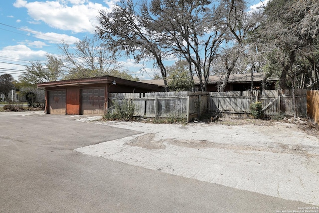 exterior space with fence and a detached garage