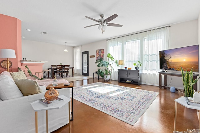 living area featuring a ceiling fan, recessed lighting, visible vents, and concrete floors