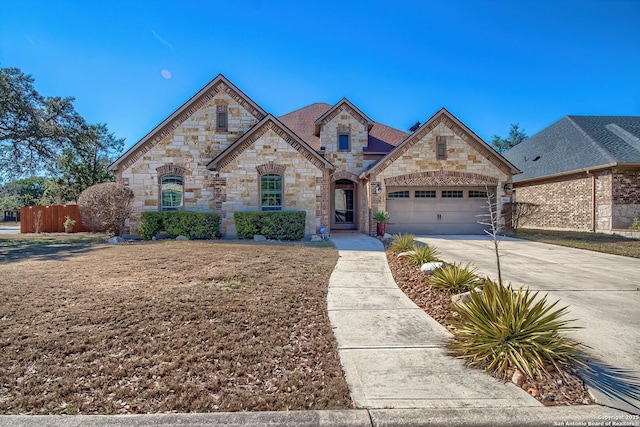 french country inspired facade featuring driveway and a garage