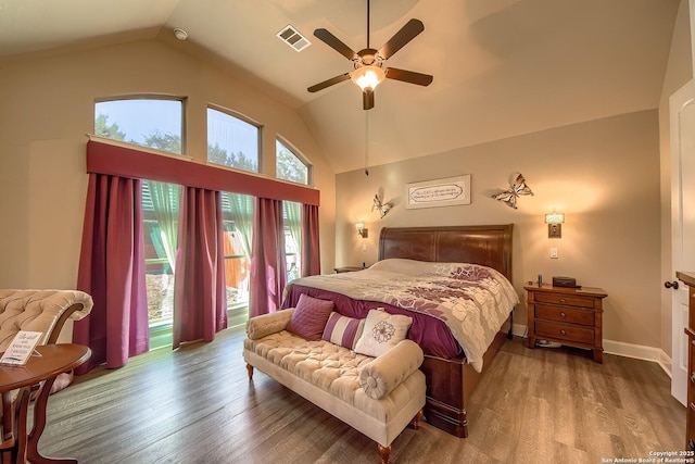 bedroom featuring baseboards, visible vents, ceiling fan, wood finished floors, and high vaulted ceiling