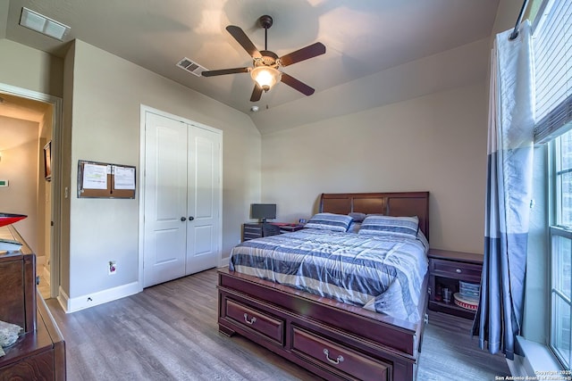 bedroom featuring a closet, visible vents, and wood finished floors