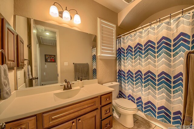 full bath with a textured wall, toilet, visible vents, vanity, and tile patterned floors