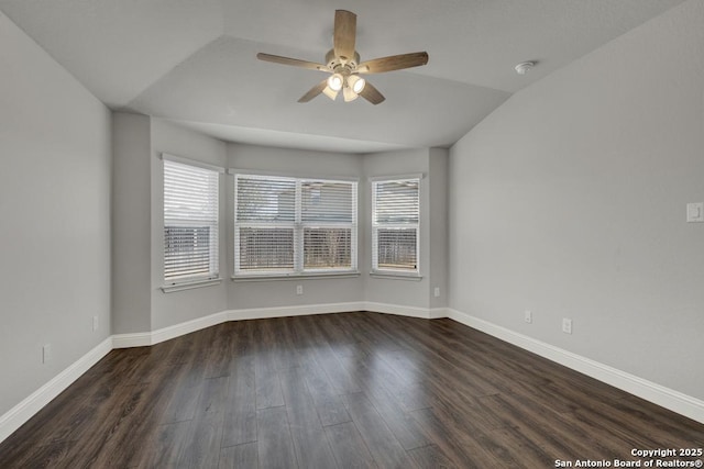 spare room featuring wood finished floors, a wealth of natural light, and baseboards