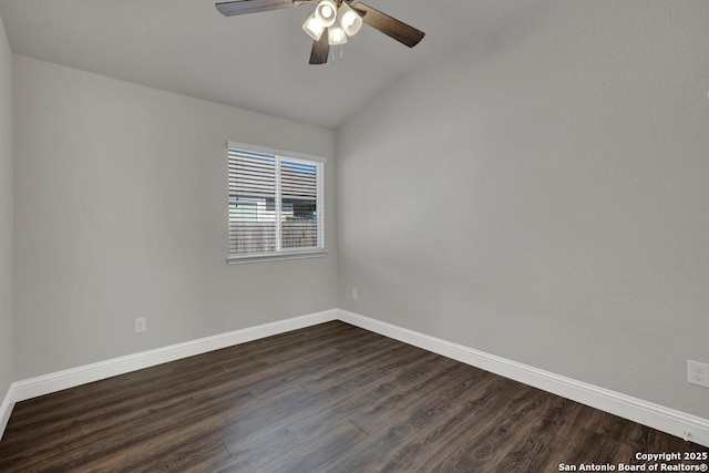 empty room with lofted ceiling, baseboards, and dark wood-style flooring