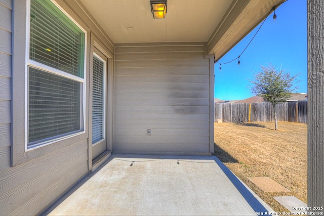 view of patio / terrace featuring fence