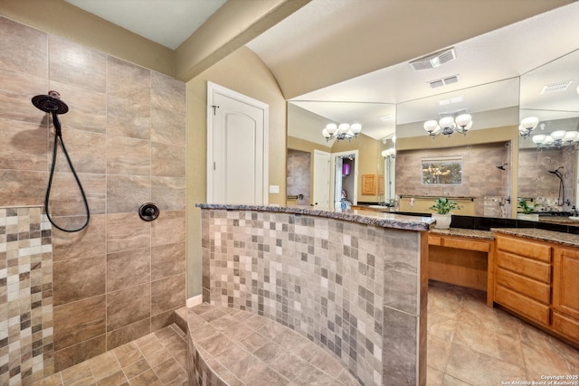 full bath with a walk in shower, vanity, visible vents, and a notable chandelier