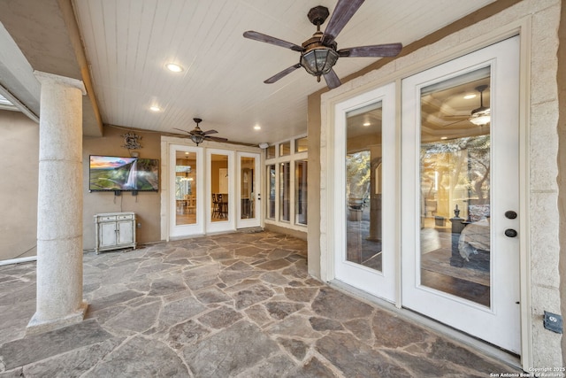 unfurnished sunroom featuring wood ceiling and decorative columns