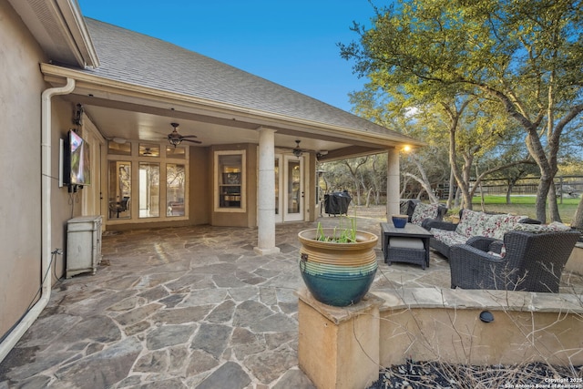 view of patio with ceiling fan, fence, an outdoor living space, and french doors