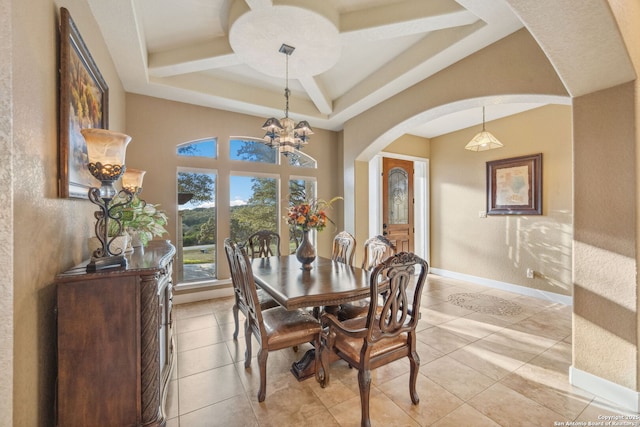 dining space featuring a chandelier, arched walkways, light tile patterned flooring, coffered ceiling, and baseboards