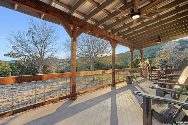 wooden deck with a ceiling fan