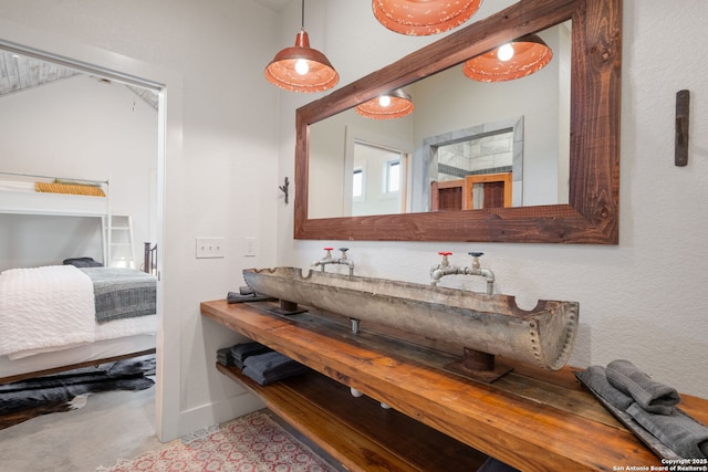 bathroom with connected bathroom and baseboards