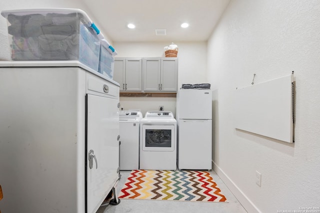 laundry area with baseboards, washing machine and clothes dryer, cabinet space, and recessed lighting