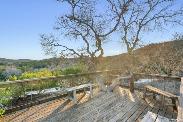 dock area featuring a deck and a wooded view