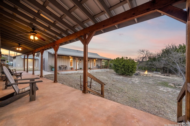 patio terrace at dusk with a ceiling fan