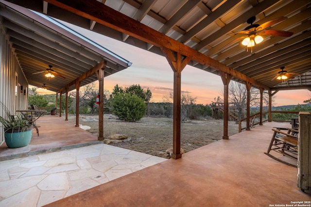 patio terrace at dusk with a ceiling fan