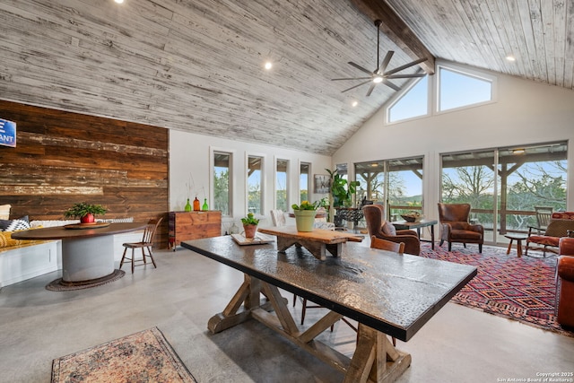 dining area featuring finished concrete flooring, wooden ceiling, high vaulted ceiling, and beam ceiling