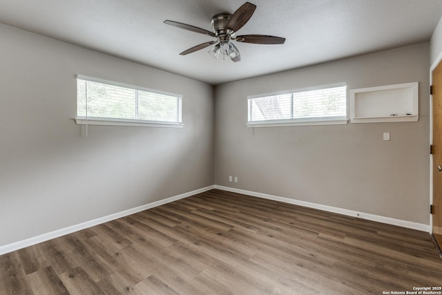 unfurnished room featuring a ceiling fan, baseboards, and wood finished floors