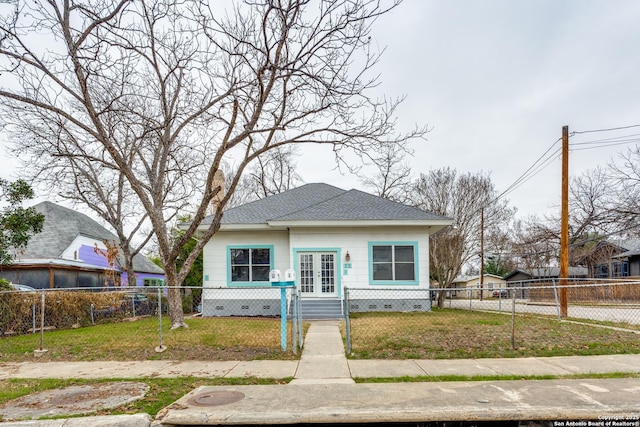 bungalow-style house with french doors, crawl space, a front yard, and a fenced front yard