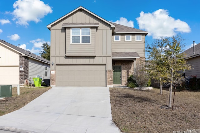 craftsman house featuring concrete driveway, brick siding, board and batten siding, and central AC unit