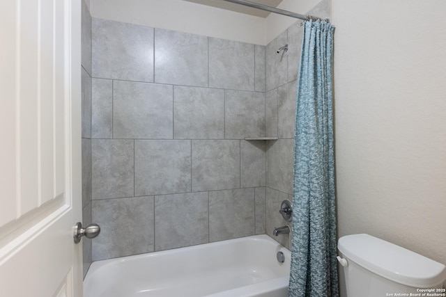 bathroom featuring shower / bath combo and toilet