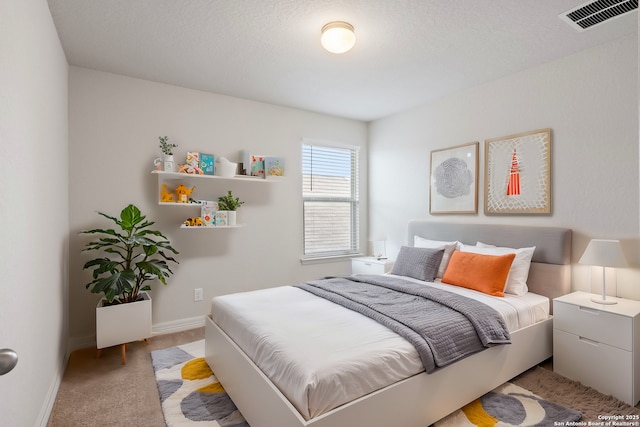 carpeted bedroom with visible vents and baseboards