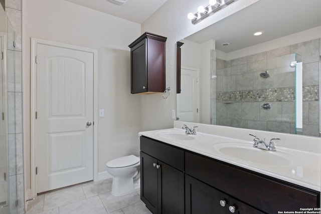 bathroom featuring tile patterned flooring, a sink, and a shower stall