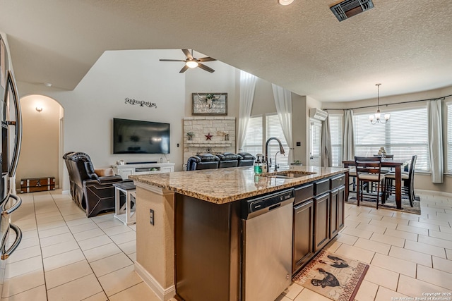 kitchen with light tile patterned floors, visible vents, appliances with stainless steel finishes, open floor plan, and light stone countertops