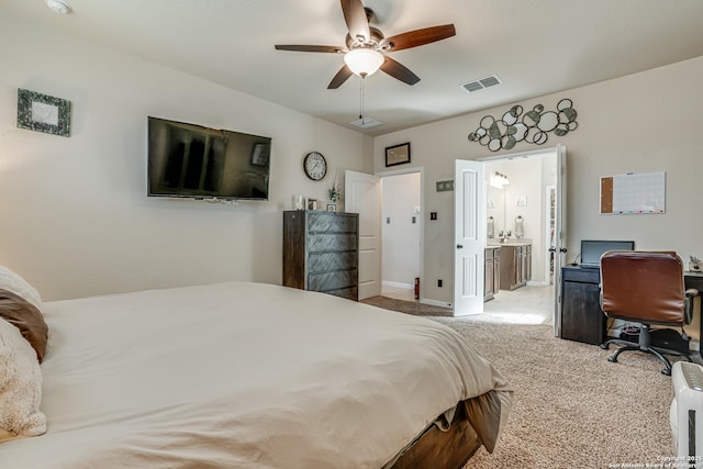 carpeted bedroom with a ceiling fan, visible vents, and connected bathroom