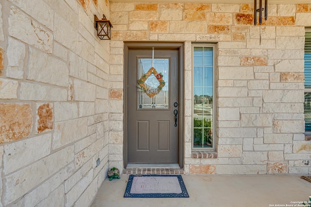 doorway to property featuring stone siding