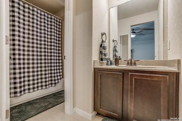 full bath featuring shower / tub combo, vanity, baseboards, and tile patterned floors