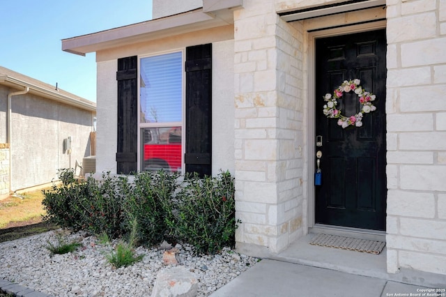 property entrance featuring stone siding