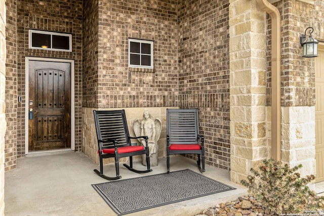 doorway to property featuring brick siding