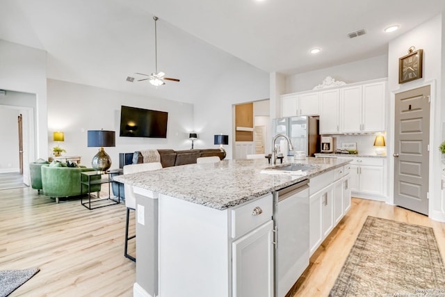 kitchen featuring a sink, visible vents, white cabinetry, appliances with stainless steel finishes, and light wood-type flooring