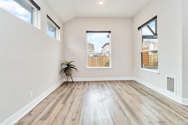 interior space with lofted ceiling, baseboards, and wood finished floors