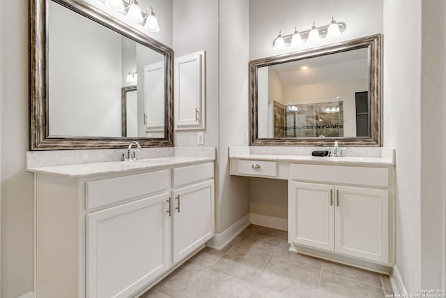 full bath featuring a stall shower, two vanities, a sink, and tile patterned floors